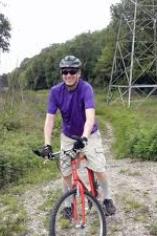 Darrell Ulm Profile Image, on mountain bike on path