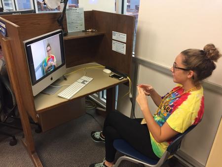 A student uses the American Sign Language Recording Station in the Student Multimedia Studio